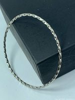 Full view of sterling silver twisted rope bangle on box