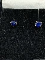 close view of both sapphire stud earrings on display pad