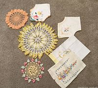 All seven textile pieces laid out on carpet for full view