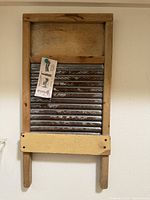 Full front view of vintage wooden washboard hanging on wall