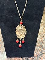 Full necklace on display stand, showing pendant and chain