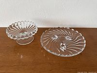 Compote and plate on wooden surface front view