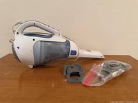 Vacuum lying on its side with wall mount and hardware