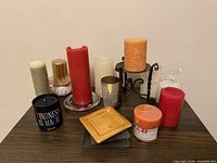 Full view of all candles, holder, plates on table