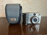 Front view of Canon PowerShot A80 camera with case