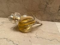 Full bottle on side showing shape and liquid level