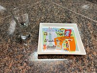 Plate and shot glass on countertop overview