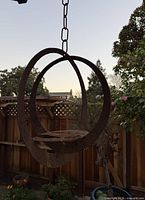 Full view of hanging steel sculpture outdoors