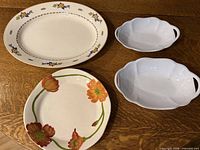 Group of four serving pieces on table