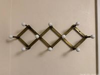 Front view showing full rack with ten ceramic pegs