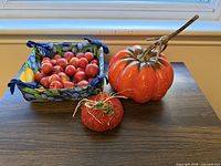 Overview of large resin pumpkin, fabric pumpkin, fabric basket with faux fruit