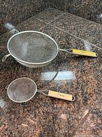 Both mesh strainers side by side on countertop