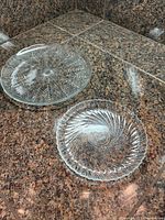 Both pressed glass plates on counter