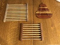 Overview of all three wooden trivets on table