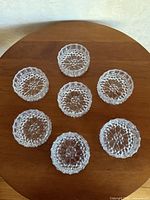 All seven clear pressed glass salt cellars displayed