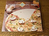Front of retail box displaying Stoneware Baking Brick with pizza image