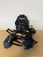 Front view of ToughBuilt Tradesman pouch with attached strap and hammer loop beside