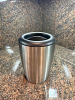 Front view of Vacu Vin stainless wine cooler showing brushed steel surface and black rim