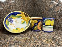 Front view of bowl and two cups showing painted designs