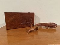 Box, fish figurine and hummingbird figurine together