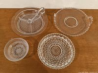 Overview of four clear glass serving pieces