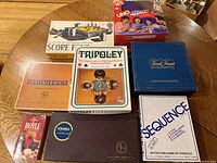 All eight boxed games laid out on table for overview