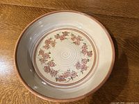 Top view showing floral decoration, spiral center, terracotta rim