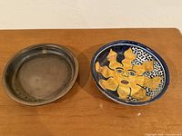 Talavera bowl and metal dish side by side, interior view