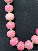 Close view of rhodonite beads and brass spacers