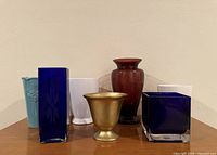 All seven vases grouped on table, front view