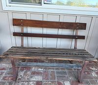 Front view of full bench showing wood slats and iron legs