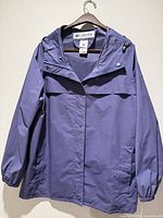 Full view of front of purple Columbia hooded jacket on hanger