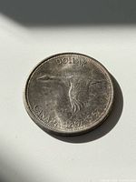 Coin reverse showing flying goose, legends DOLLAR CANADA 1867-1967