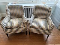 Front view of two matching blue-white striped armchairs