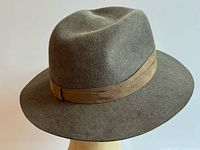 Side view of taupe wool fedora with tan band