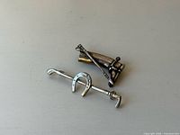 Front view of both sterling silver equestrian brooch pins