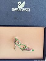 Front view of Swarovski shoe brooch inside branded box
