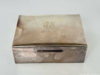 Top view of closed silver plated box showing monogram and date
