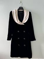Front view of black velvet dress on hanger