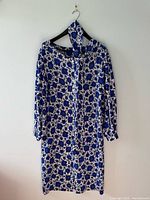 Full view of dress on hanger with matching scarf displayed