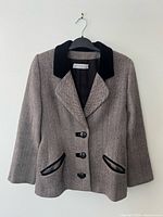 Front view of herringbone blazer with black velvet collar and pocket trim