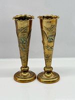 Front view of both brass owl vases