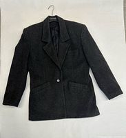 Front view of charcoal cashmere jacket showing single-button closure and pockets