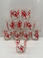 12 clear lowball glasses with red lobster graphic, stacked pyramid