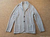 Full view of grey knit blazer cardigan laid flat