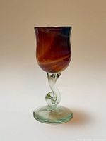 Full view of multicolour art glass goblet showing bowl, twisted stem, and foot