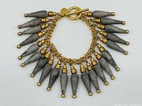 Full view of bracelet laid flat showing all agate spikes and toggle clasp