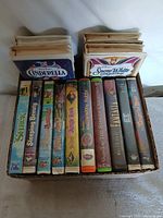 Box with 14 VHS tapes, front spines visible