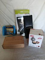 All four kitchen items grouped: waffle maker box, decorator boxes, mac cooker, slicer with box