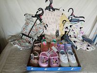 Group shot of all clothing on hangers with tray of shoes